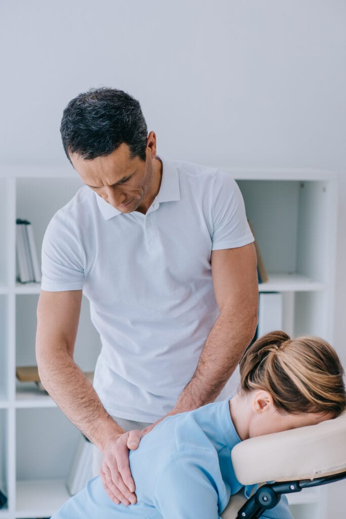 masseur doing office massage for businesswoman