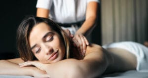 Young and healthy woman in spa salon. Traditional Tulsa Swedish massage therapy and beauty treatments.