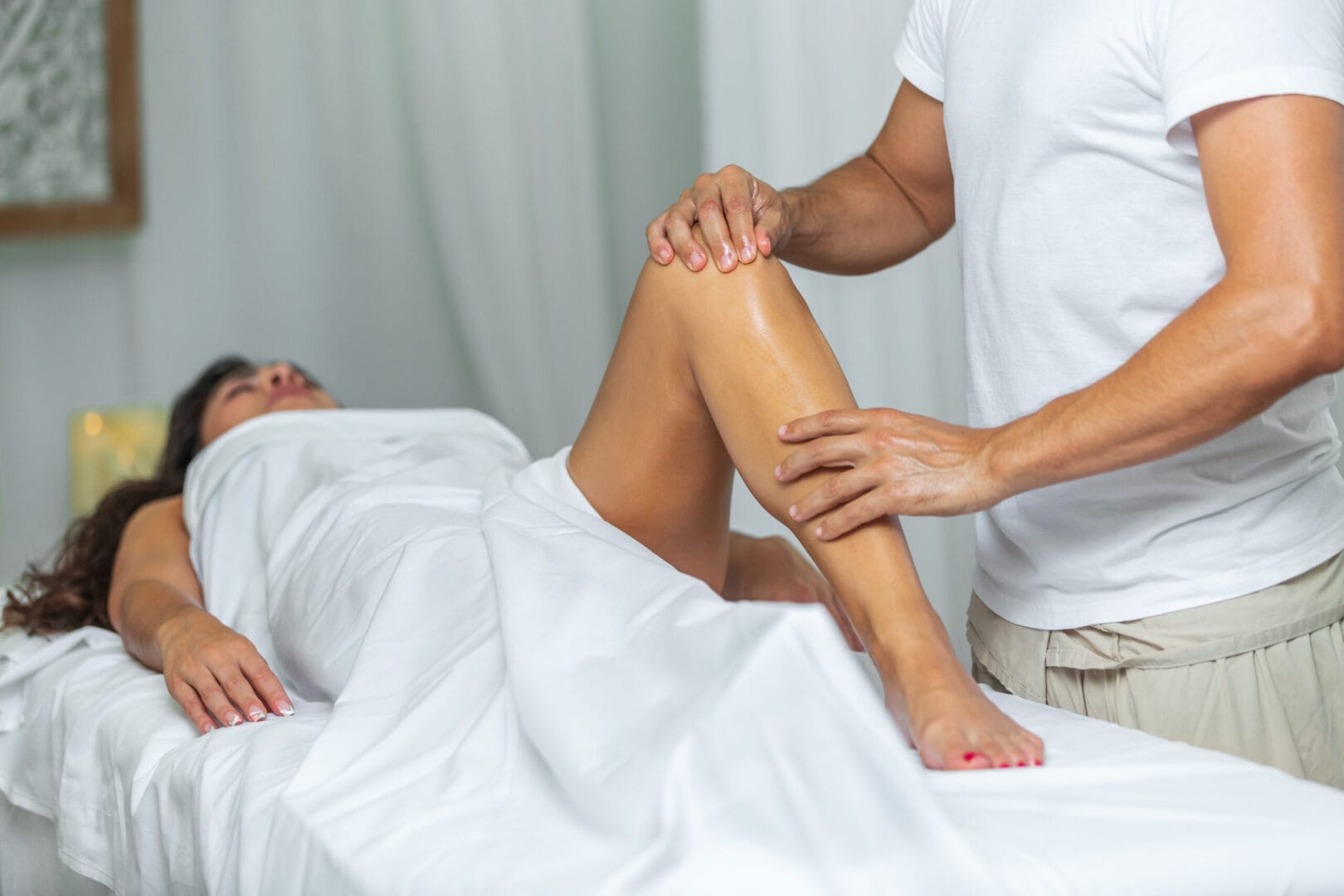 therapist doing a leg massage to woman in spa salo 2023 11 27 05 34 49 utc scaled | Medical Massage of Tulsa